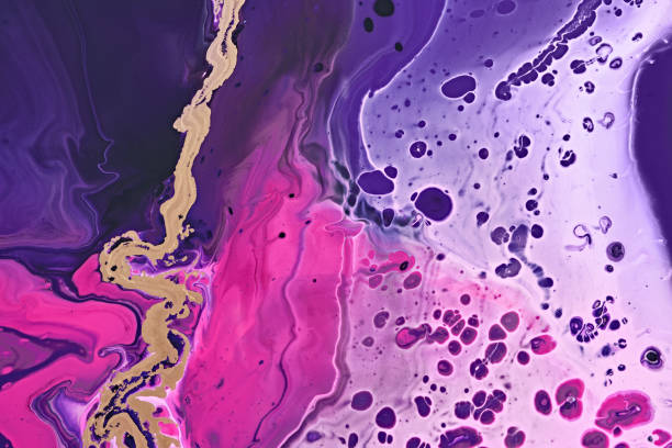 istock Fluid Art. Metallic gold abstraction and bubbles on purple waves. Marble effect background or texture 1357127116