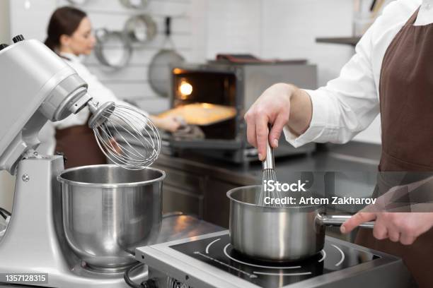 Male Pastry Chef Cooks A Berry Kuli In A Saucepan For Filling A Cake Stock Photo - Download Image Now