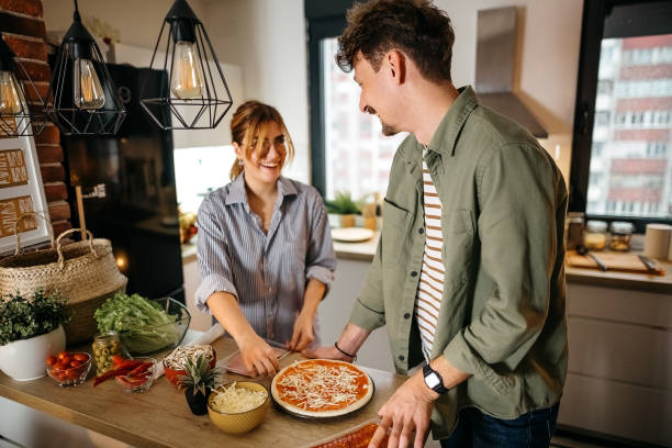istock Couple making pizza together 1357129142
