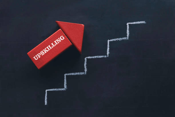 Upskilling red arrow with a ladder on a blackboard. stock photo