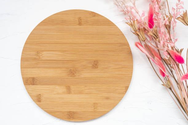istock Blank round wood sign with space for text lies on white background. 1357131443