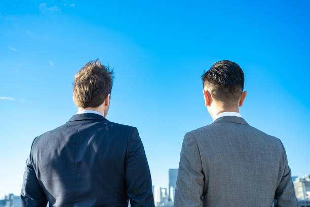 istock Backs of two men in suits 1357132551