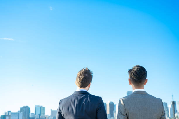 istock Backs of two men in suits 1357132571