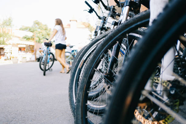 Number of mountain bikes are on the street for sale. Number of mountain bikes are on the street for sale. Close-up on a bicycle wheel. rent a bike stock pictures, royalty-free photos & images