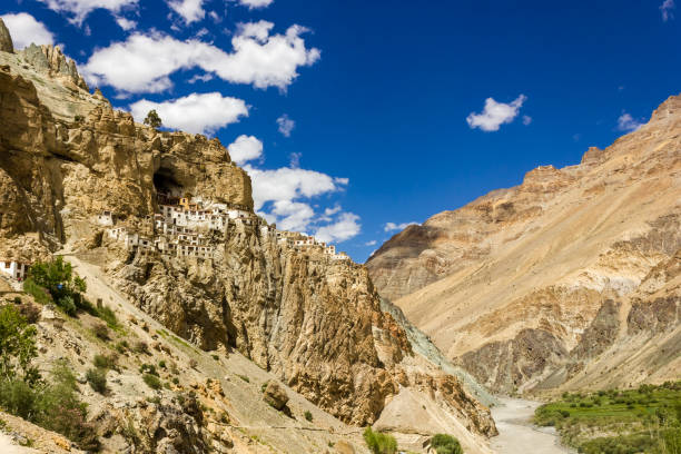 The ancient Tibetan Buddhist Phuktal monastery in Zanskar The ancient Tibetan Buddhist Phuktal monastery of on a steep rocky hillside in the Zanskar region in Ladakh in the Indian himalaya. gompa stock pictures, royalty-free photos & images