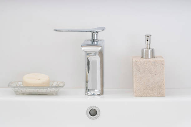istock faucets and soaps on white and clean bathroom sink 1357139290