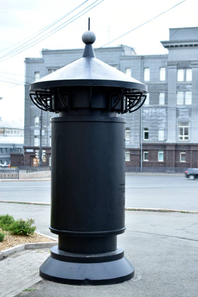 istock Antique iron curbstone with advertisements in the city 1357140656