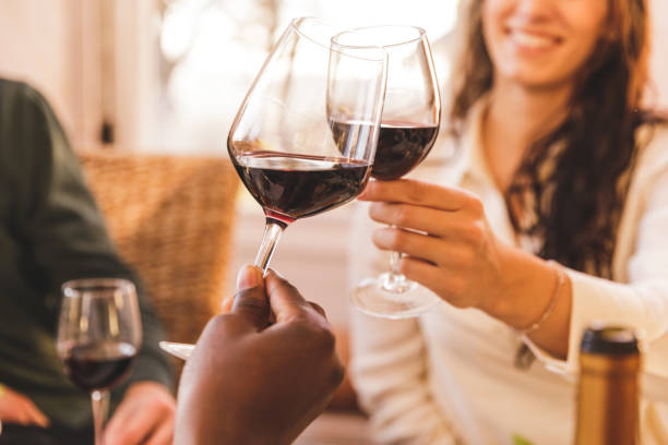 istock Friends making celebratory toast with red wine 1357144110