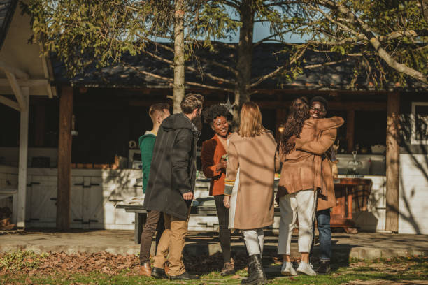 istock Friends embracing and greeting each other upon arrival as guests 1357144209