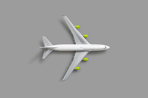 Commercial airliner with green jet engines on gray background