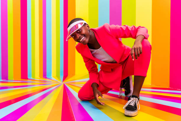 istock Beautiful young woman dancing and having fun inside a rainbow box room 1357145626