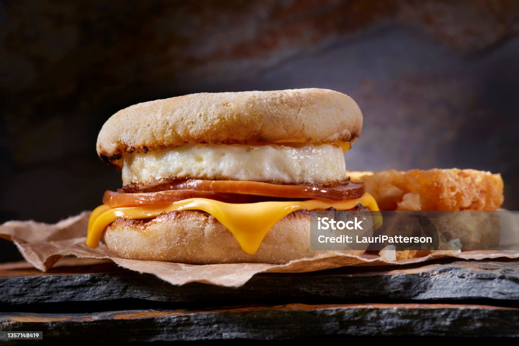 Classic Ham and Egg Breakfast Sandwich Classic Ham and Egg Breakfast Sandwich with Cheese on a Toasted English Muffin with Hash Brown Patties Cheese Stock Photo