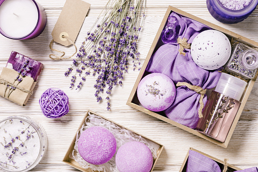 Lavender bath bombs, sea salt, sachets, aromatherapy sleep spray, fragrant and healthy spa products with lavender essential oil. Herbal medicine concept, cosmetic for body treatment, wooden table