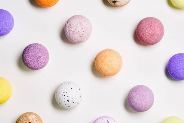istock Flat lay composition with bath bombs pink, violet, purple colored on white paper background. Bathing balls with  essential oils for relaxation and aromatherapy. Body care natural products 1357148563