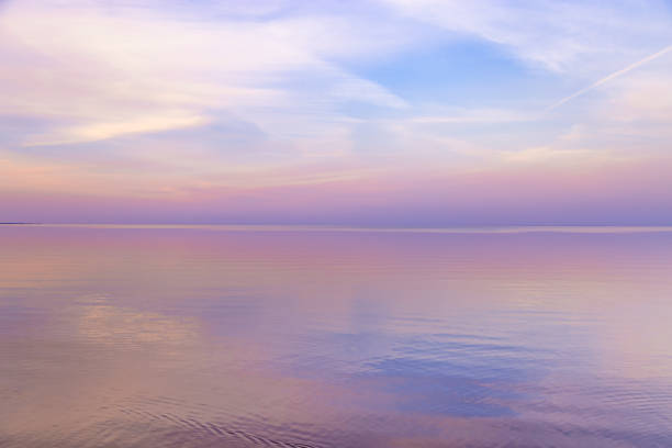 istock Sky background on sunset, colorful clouds. Nature abstract composition with reflections on sea water. Nature environment. 1357148591