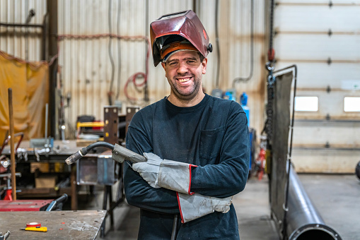 Portrait of a welder taking a break in a factory.