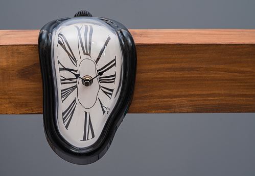 Antique wall wooden clock with hands of the clock and gold pendulum