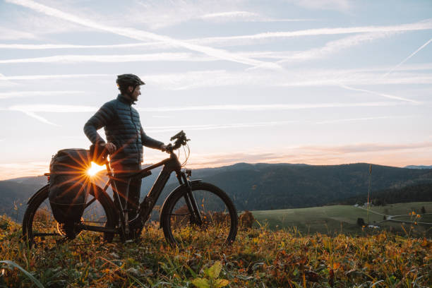 istock E-mountain biker relaxes in meadow, at sunrise 1357153133