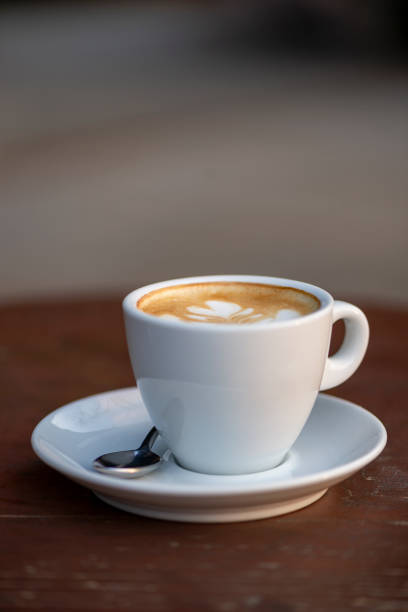 istock White cup of double espresso coffee wit sugar and milk. 1357154786