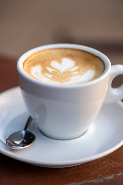 istock White cup of double espresso coffee wit sugar and milk. 1357154812