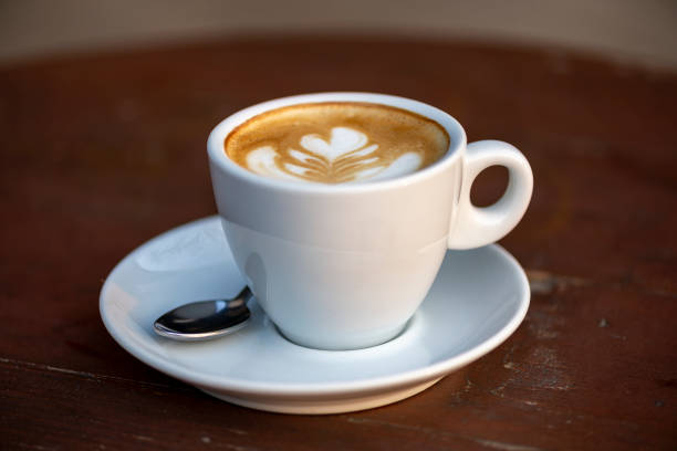 istock White cup of double espresso coffee wit sugar and milk. 1357154818