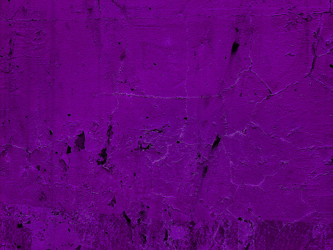 surface of purple old weathered plaster concrete wall background. abandoned and distressed violet stucco wall texture background.  wall fragment with scratches and cracks.