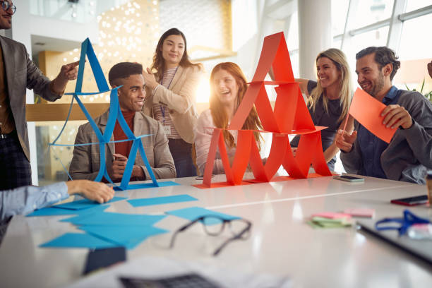 A group of young business people is enjoying team building games during a break at work. Business, people, company stock photo