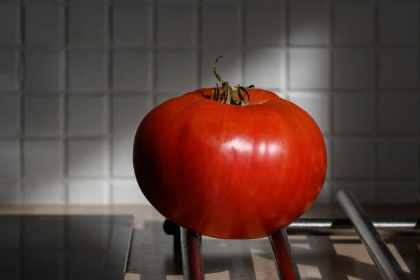 istock One ripe tomato on the kitchen table close-up 1357159340