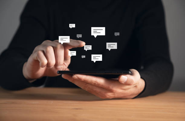 istock man holding phone or tablet with letters 1357159417