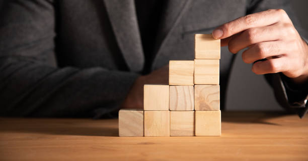 istock Hand holding wooden block cubes 1357159455