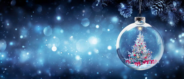 istock Christmas Tree In Bauble Hanging Fir Branch With Gift Boxes In Blue Abstract Night 1357159885