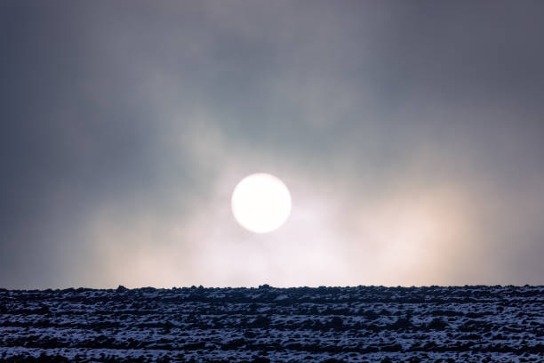 Frosty, misty dawn with sun on the horizon