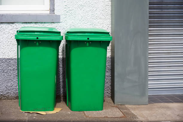 istock Green recycle wheelie bins in row for collection 1357163845