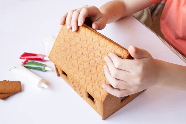 istock boy collects christmas gingerbread house 1357164913