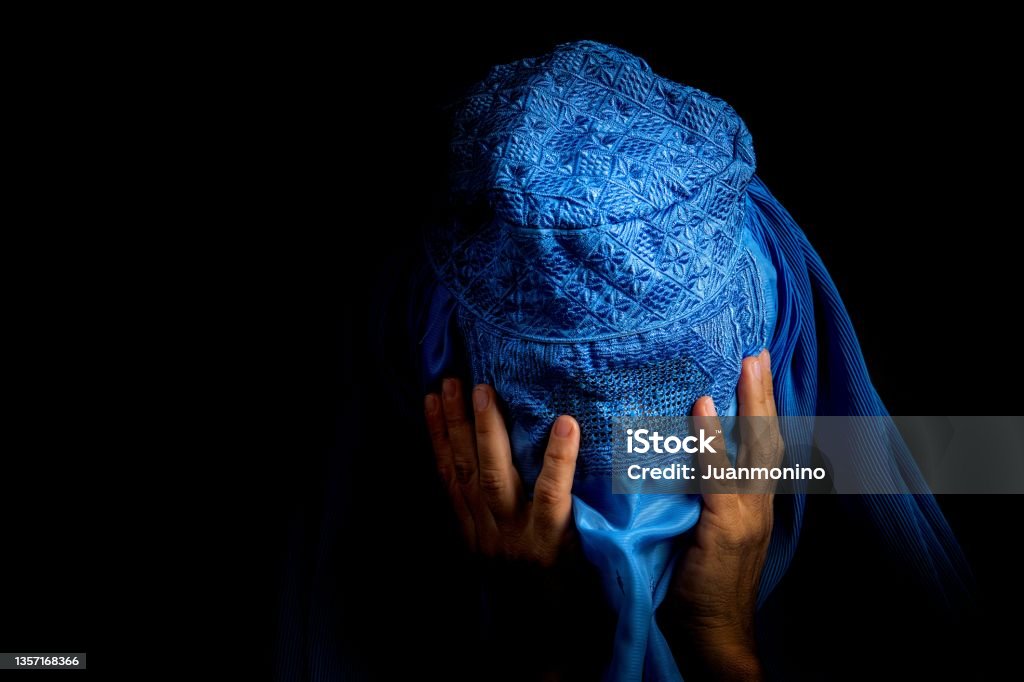 Sad Afghan Woman wearing a burka looking down Afghanistan Stock Photo