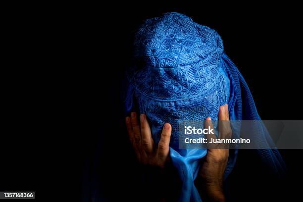Sad Afghan Woman Wearing A Burka Looking Down Stock Photo - Download Image Now - Afghanistan, Women, Only Women