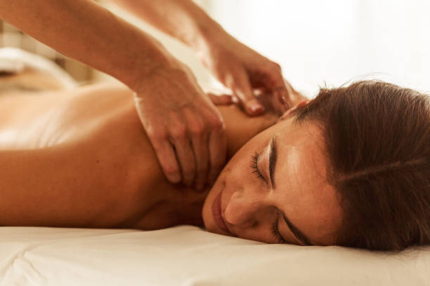 istock Woman receiving neck massage at spa 1357169214