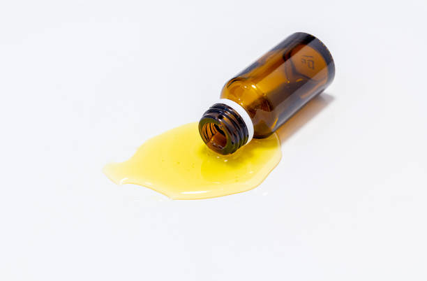 istock spilled yellow liquid from glass bottle 1357169414