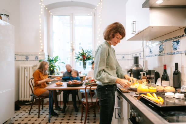 istock Woman cooking christmas dinner in kitchen 1357169495