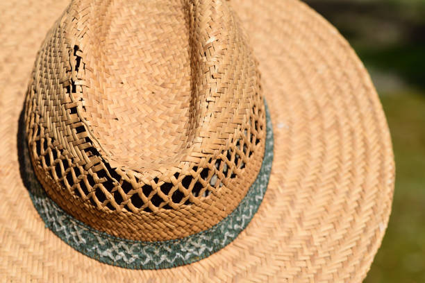 istock An old broken straw hat from the front and as a close-up, outdoors 1357174513