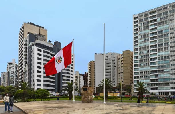 Grau in Lima Park, Peru Lima, Peru, November 22, 2021: Peruvian flag is fluttering in the Parque Grau in the Miraflores district. city street street corner tree stock pictures, royalty-free photos & images