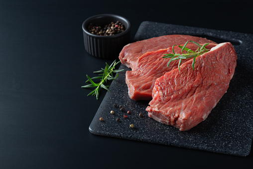 Fresh raw beef steak sirloin with rosemary.