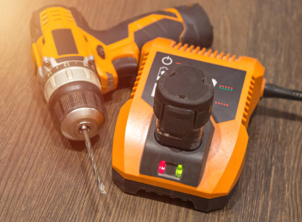 istock cordless drill .screwdriver, drill, charger and battery on boards 1357180709