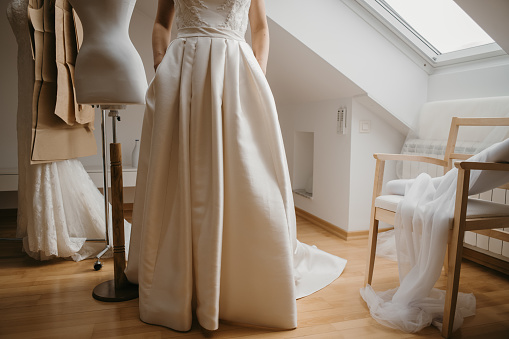 Close up of woman in wedding dress while standing in bridal shop