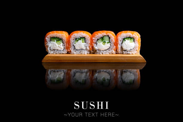istock Salmon sushi roll with reflection isolated on black background ready food banner with text space 1357181759