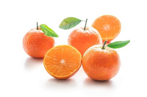 Tangerines group of citrus fruits closeup with leaves isolated on white background