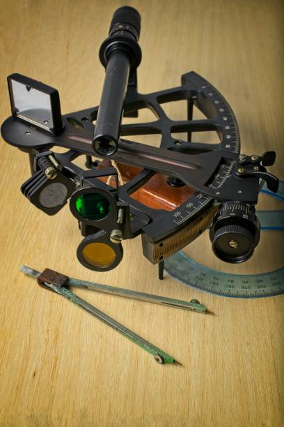 istock Vintage nautical sextant with protractor and dividers set on navigation chart table 1357189339