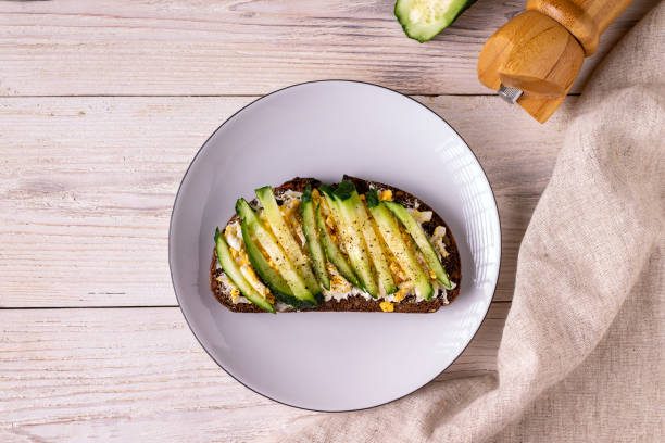 istock sandwich with cheese, egg, cucumbers, spices on a white wooden background copy space 1357192881
