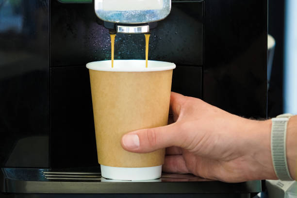 istock Close-up barista under using coffee making machine at cafe to make coffee customer. Preparing coffee in automatic coffee machine in cafe 1357192928