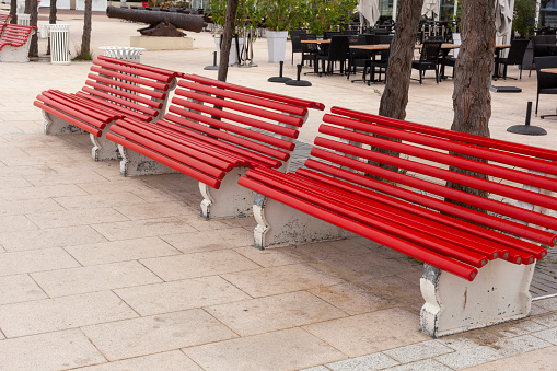 wooden red benches in a city